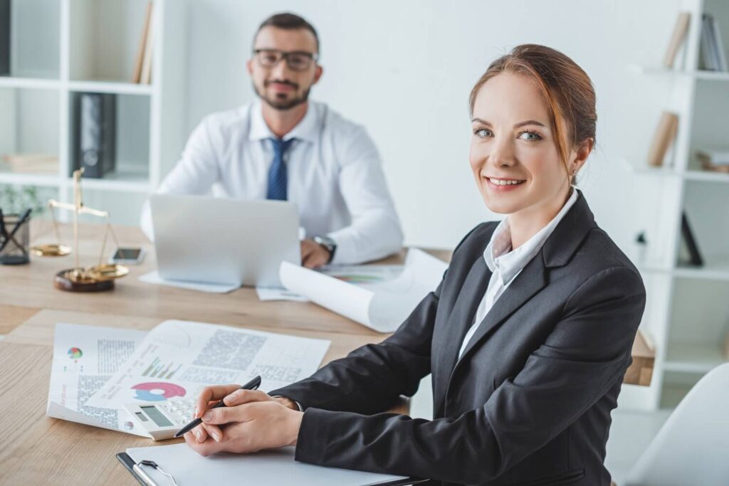 Confident professional sitting at desk during office consultation.