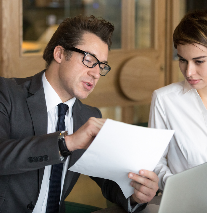 Business professionals discussing a document during a corporate consultation meeting.