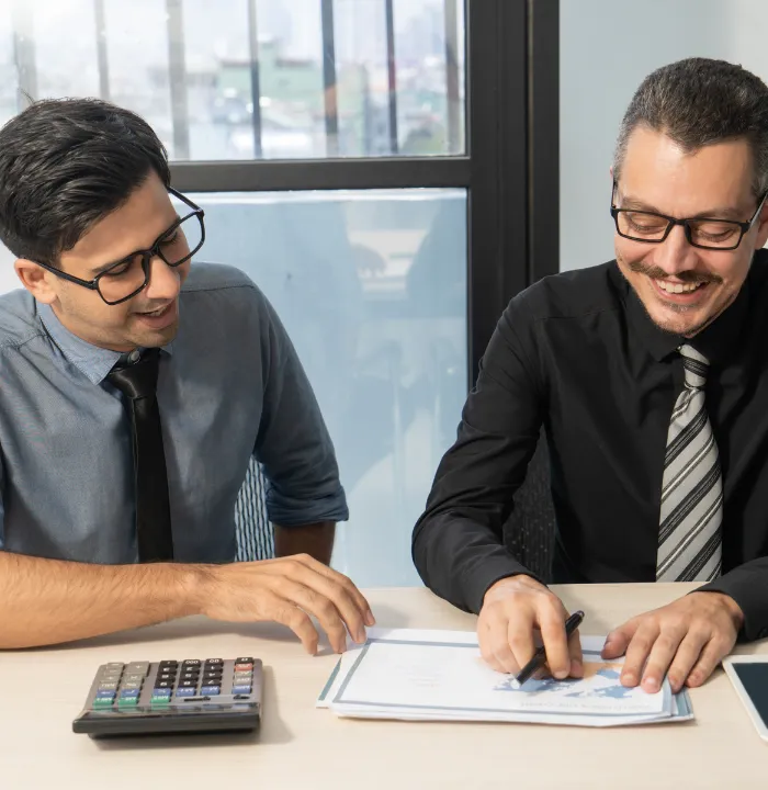 Business professionals reviewing corporate tax documents and calculations