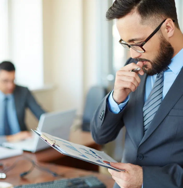 Professional workspace where paperwork is being authorized and processed.
